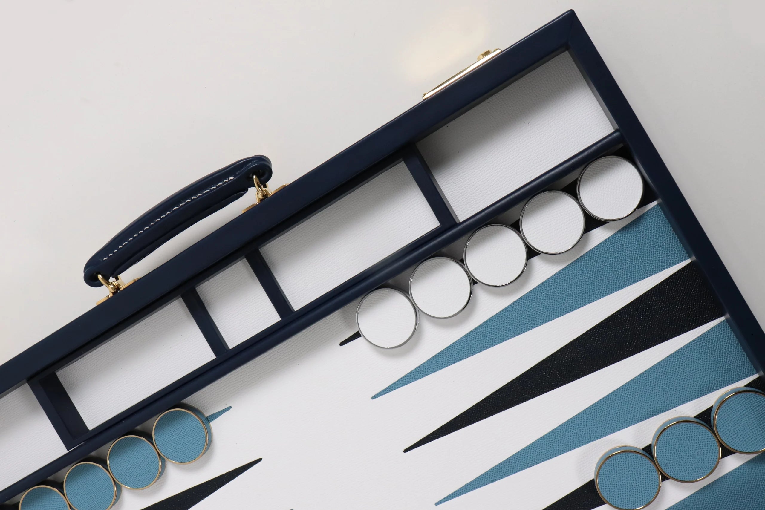 Handcrafted Bridle Hide backgammon set in deep navy leather with gilt detailing by Geoffrey Parker for EB London.