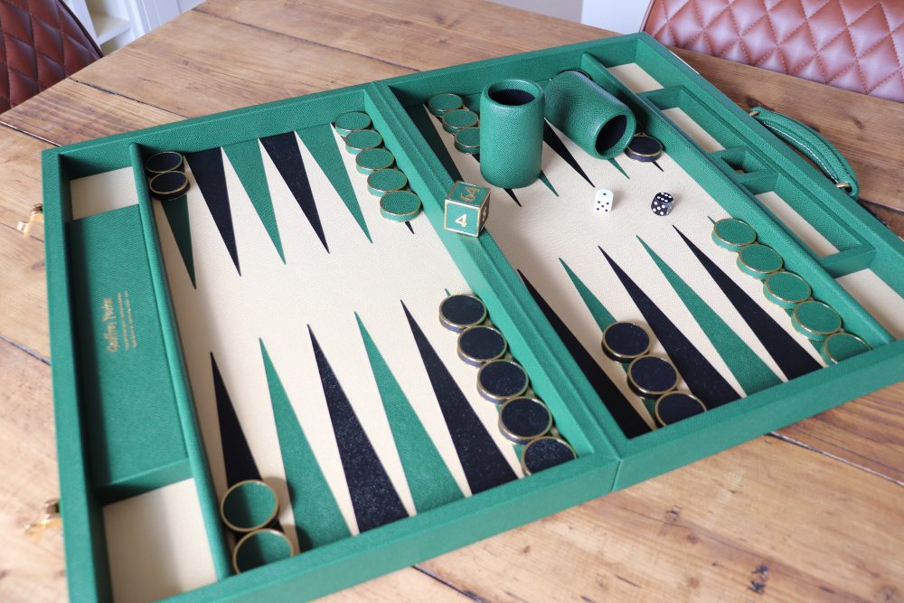 Conifer green tournament backgammon set with magnolia playing surface, leather and metal stones, and luxury dice cups handcrafted in England by Geoffrey Parker.