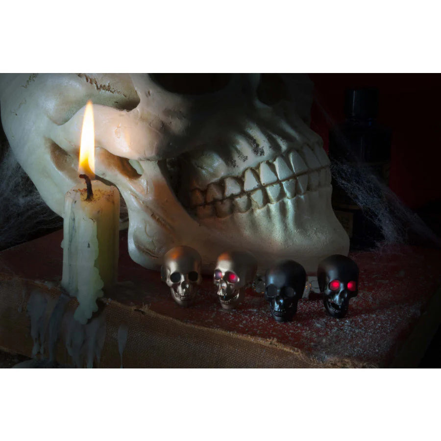 Skull with lit candle and small decorative skulls on a dark background - Cufflinks - EB London