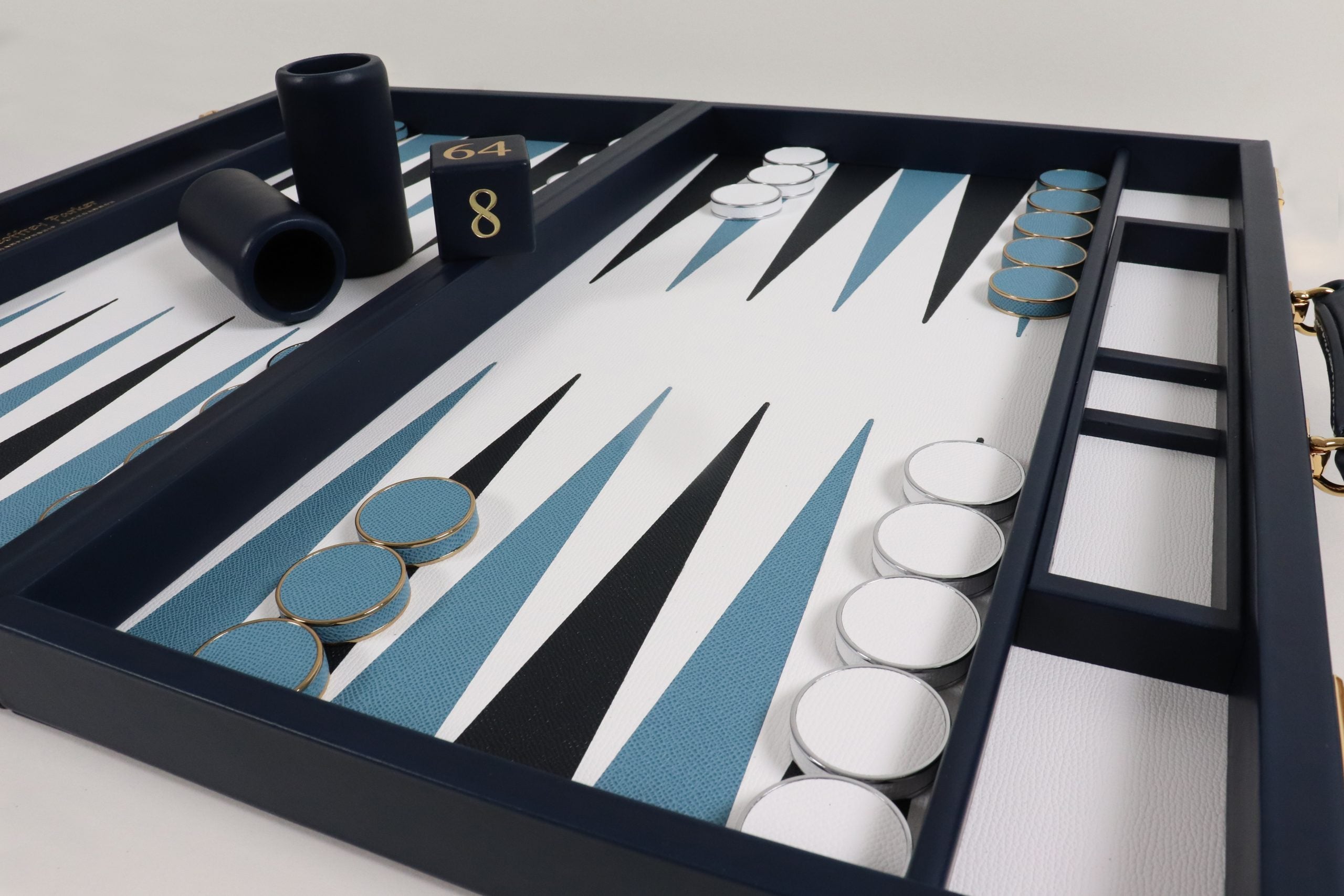 Handcrafted Bridle Hide backgammon set in deep navy leather with gilt detailing by Geoffrey Parker for EB London.