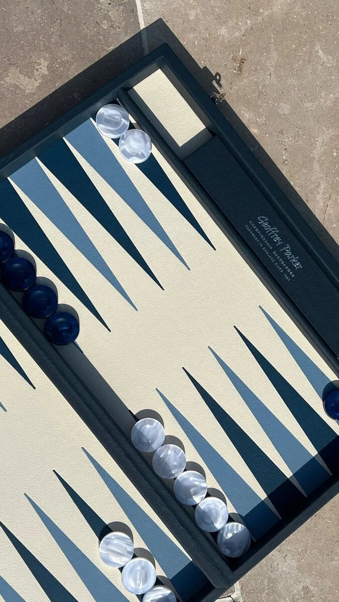 Luxury leather tournament backgammon board in Suffolk Blue with blue and white acrylic checkers, handcrafted in England by Geoffrey Parker for EB London.
