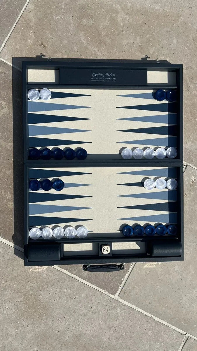 Luxury leather tournament backgammon board in Suffolk Blue with blue and white acrylic checkers, handcrafted in England by Geoffrey Parker for EB London.
