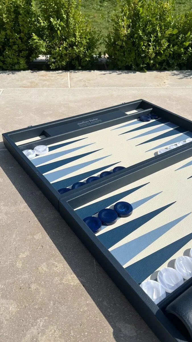 Luxury leather tournament backgammon board in Suffolk Blue with blue and white acrylic checkers, handcrafted in England by Geoffrey Parker for EB London.